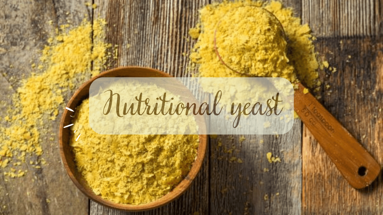 A bowl and a spoon with nutritional yeast in it.