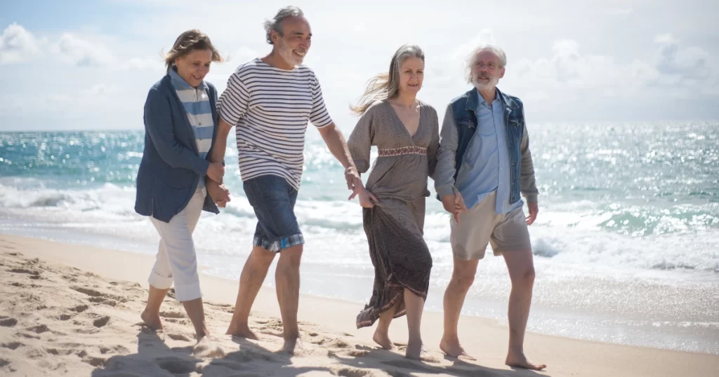US senior couples enjoying on a beach.