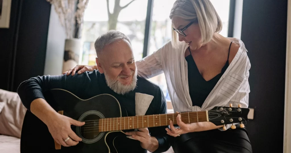 A US senior is playing guitar.