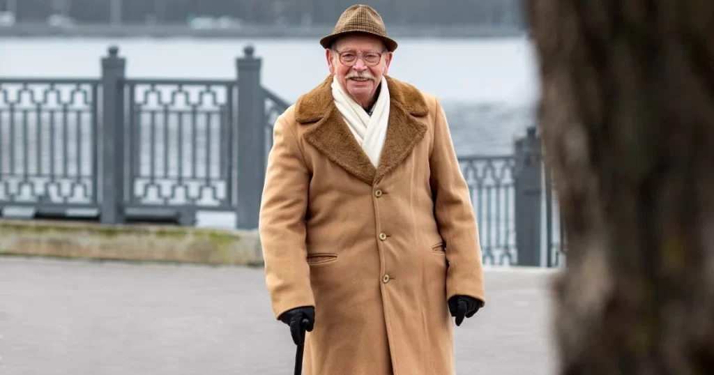 US senior out for a walk on a walking trail on river bank.